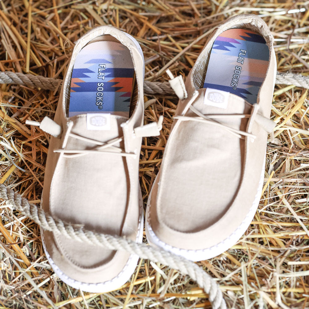 Pair of beige slip-on shoes with Cowboy Core FLAT SOCKS inside on hay or straw background, with rope #size_small-up-to-women-s-11-men-s-10