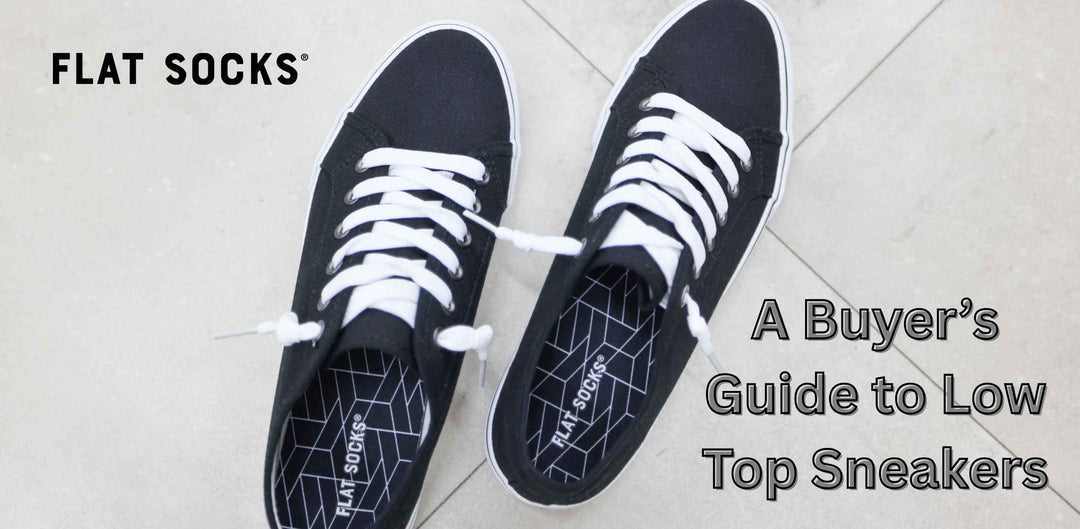 A pair of black low top sneakers on tile floor