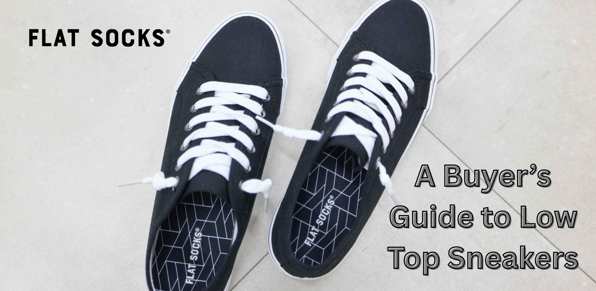 A pair of black low top sneakers on tile floor