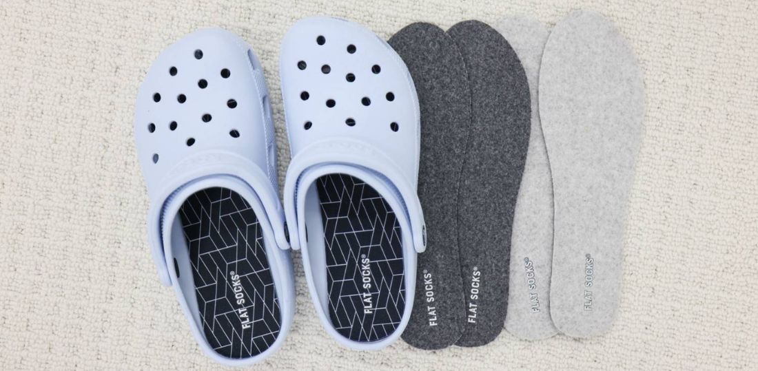 Light blue Crocs next to dark grey and light grey FLAT SOCKS