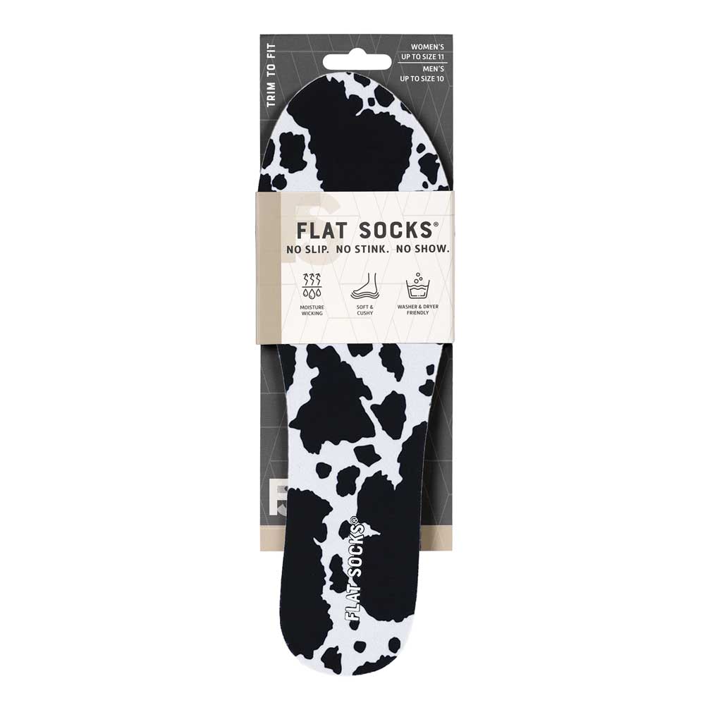 View of the front of white and black animal print FLAT SOCK in packaging, FLAT SOCKS no slip, no stink, no show. Moisture wicking, soft & cushy, washer & dryer friendly. Features white and black cow print on insole liner #size_small-up-to-women-s-11-men-s-10