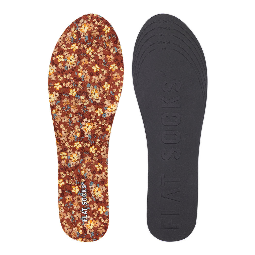 View of top fabric on left liner, view of bottom of right liner. Insole liner Features orange, yellow, and tan flowers printed on top fabric. Bottom of FLAT SOCK is 100% black polyurethane foam and provides slight cushion under foot and its super grippy surface helps liner stay in place all day #size_small-up-to-women-s-11-men-s-10