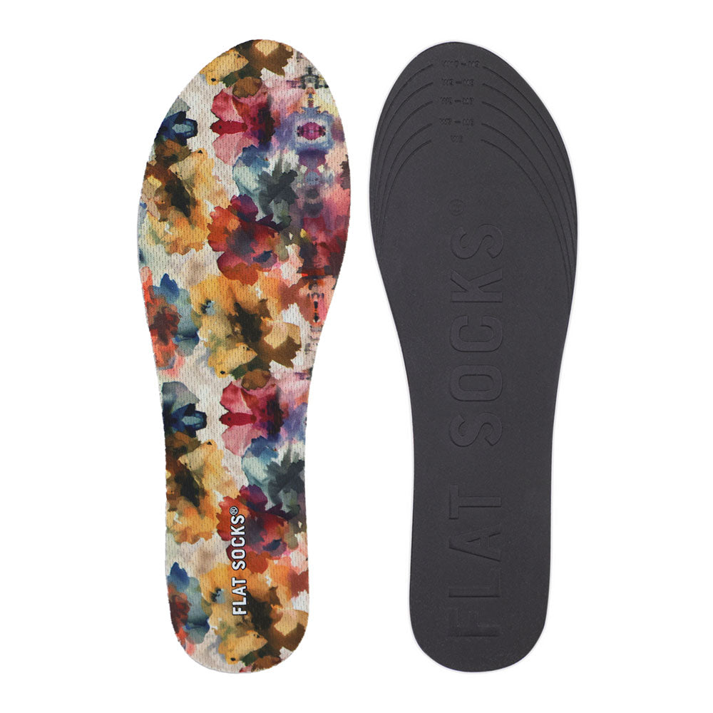 View of top fabric on left liner, view of bottom of right liner. Insole liner features yellow, amber, deep blue, and maroon wildflower watercolor floral print on top fabric. Bottom of FLAT SOCK is 100% black polyurethane foam and provides slight cushion under foot and its super grippy surface helps liner stay in place all day #size_small-up-to-women-s-11-men-s-10