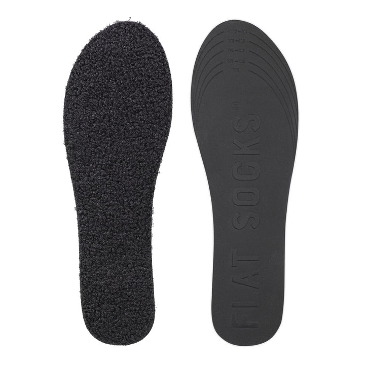 View of top fabric on left liner, view of bottom of right liner. Insole liner features black curly poodle-like faux fur. Bottom of FLAT SOCK is 100% black polyurethane foam and provides slight cushion under foot and its super grippy surface helps liner stay in place all day #size_small-up-to-women-s-11-men-s-10