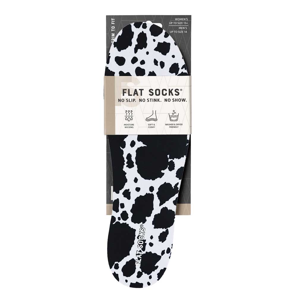 View of the front of white and black animal print FLAT SOCK in packaging, FLAT SOCKS no slip, no stink, no show. Moisture wicking, soft & cushy, washer & dryer friendly. Features white and black cow print on insole liner #size_large-up-to-women-s-13-men-s-14