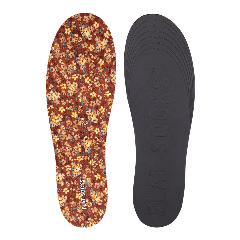 View of top fabric on left liner, view of bottom of right liner. Insole liner Features orange, yellow, and tan flowers printed on top fabric. Bottom of FLAT SOCK is 100% black polyurethane foam and provides slight cushion under foot and its super grippy surface helps liner stay in place all day #size_large-up-to-women-s-13-men-s-14