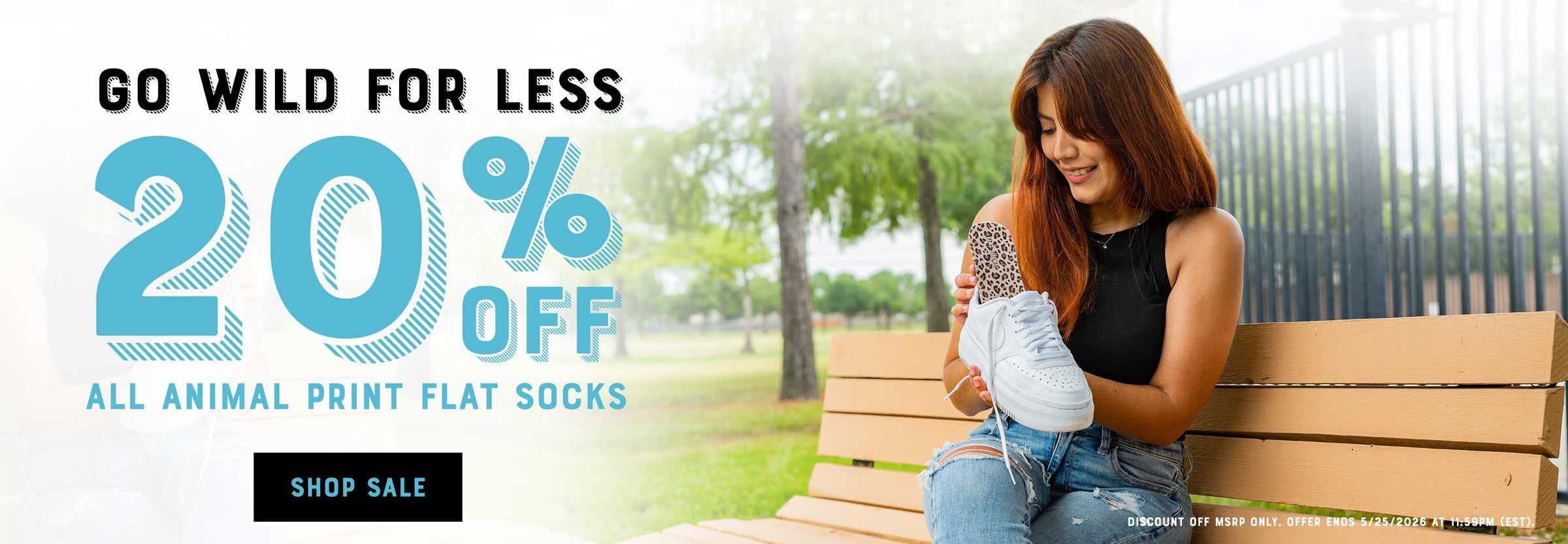 Promotional advertisement for 20% off animal print flat socks with a woman sitting on a bench wearing white sneakers.
