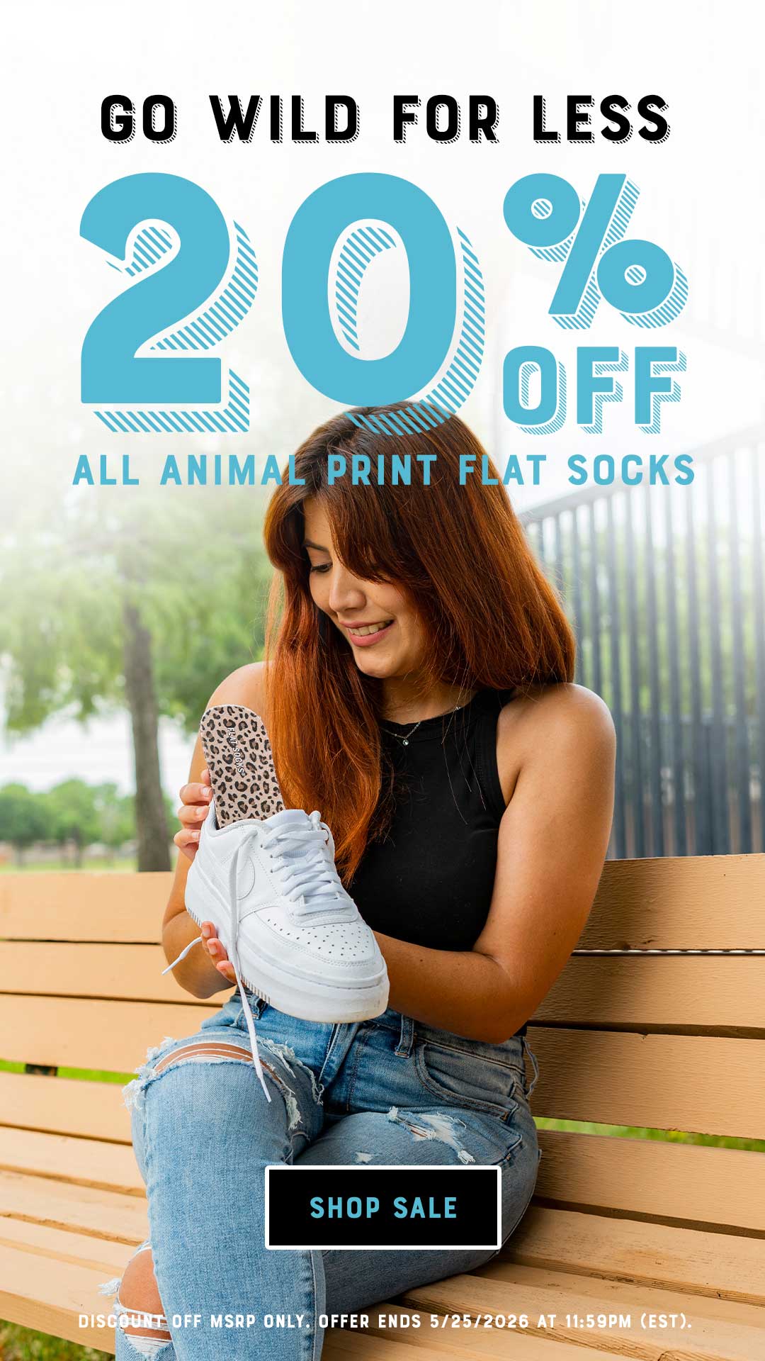 Promotional advertisement for 20% off animal print flat socks with a woman sitting on a bench wearing white sneakers.
