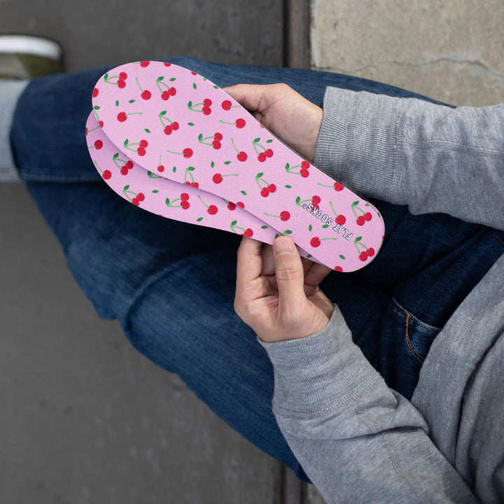 Person holding a pair of Cherry Darling print FLAT SOCKS #size_large-up-to-women-s-13-men-s-14