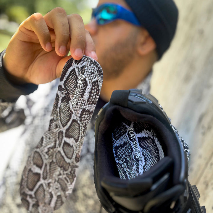 Man wearing blue sunglasses while holding up snake skin FLAT SOCKS #size_small-up-to-women-s-11-men-s-10