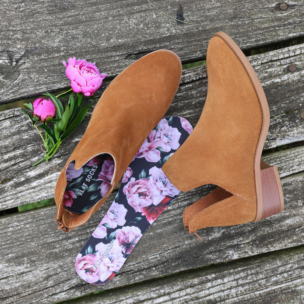 Light brown suede boots, pink peony flowers, and Peony FLAT SOCKS sitting on rustic wood #size_small-up-to-women-s-11-men-s-10