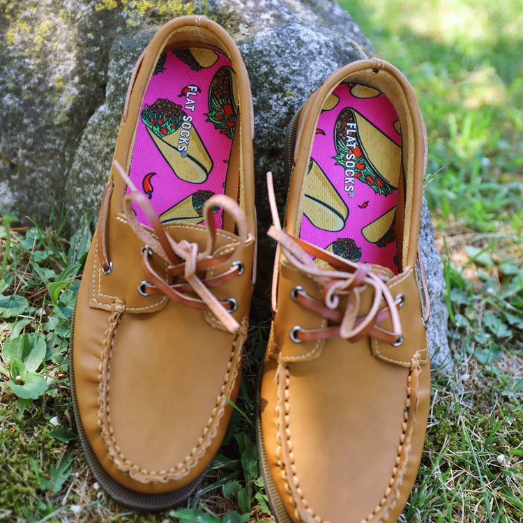 Pair of brown leather loafers sitting against a rock with pink taco print FLAT SOCKS inside #size_large-up-to-women-s-13-men-s-14